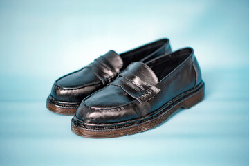Detail of full black tassel shoes with rubber soles made of genuine cowhide with neat patterns...