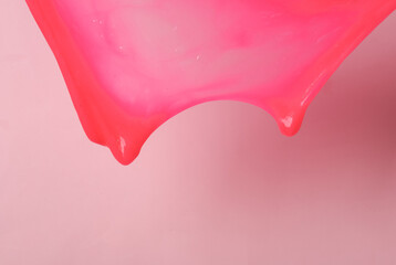 Pink stretch slime on a pink background. Halloween background