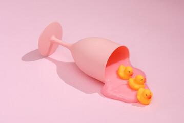 Creative layout, glass with rubber duck on bright pink background with shadow. Visual trend. Fresh idea. Concept pop