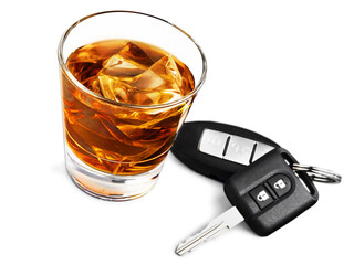 glass of liquor with car key