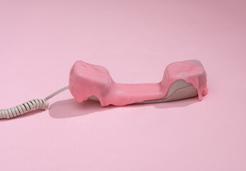 Creative 80s layout, Retro phone tube with slime on pink background with shadow. Visual trend....