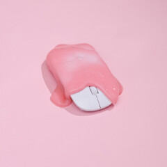 Creative layout, pc mouse with slime on pink background with shadow. Visual trend. Fresh idea. Concept pop