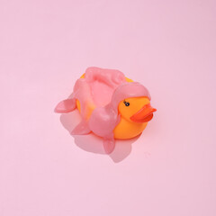 Creative layout. Rubber duck with slime on pink background with shadow. Visual trend. Fresh idea. Concept pop