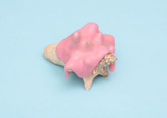 Creative summer layout, Seashell with slime on blue pastel background. Visual trend. Fresh idea. Concept pop