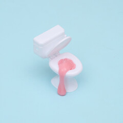 Creative layout, toilet with slime on pastel bue background. Visual trend. Fresh idea. Concept pop