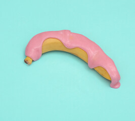 Creative food layout, Banana with slime on blue background with shadow. Visual trend. Fresh idea. Concept pop