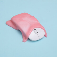 Creative layout. Pc mouse with pink slime on blue pastel background. Visual trend. Fresh idea