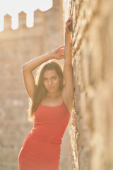 Girl with tight red dress and long straight hair posing in Toledo