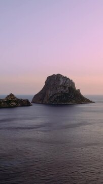 Aerial view of Es Vedra Ibiza during sunset. Showing ocean and clear skies. Vertical video.