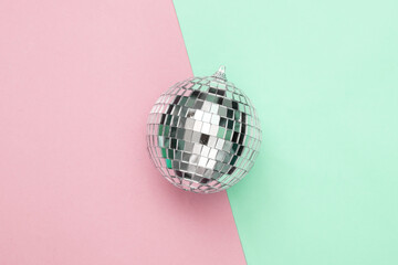 Disco ball on a blue-pink pastel background. Top view. Flat lay. Minimalism party concept