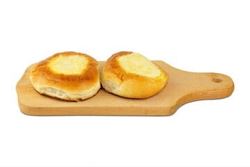 two buns with cottage cheese in on a kitchen board isolated from the background