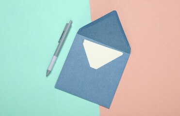 Craft envelope with letter and pen on blue pink pastel background. Top view