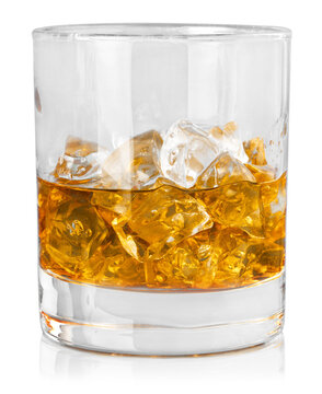 Glass of whiskey and ice on wooden table