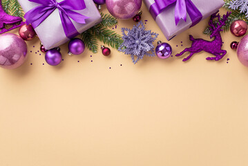 New Year concept. Top view photo of purple gift boxes with bows pink and violet baubles deer ice skates flower ornaments pine branches and confetti on isolated pastel beige background with copyspace