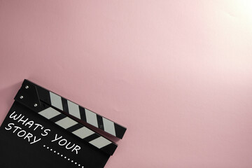 whats your story  text on clapper borad against pink background
