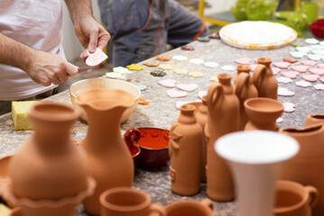 Fototapeta na wymiar Man professional potter making pottery in his pottery workshop