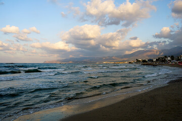 Fototapeta na wymiar Evening over the Aegean Sea in Crete. Low hanging clouds. Mountains water horizon