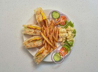 chicken club sandwich with fries, russain salad served in a dish isolated on grey background top view of indian, pakistani food
