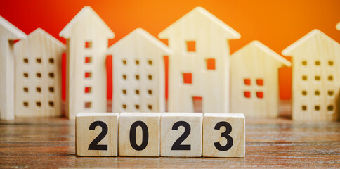 Wooden blocks 2022 and houses. Family budget planning for next year. Investments, plans, savings....