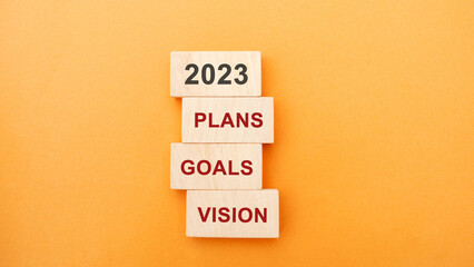Wooden blocks with the word 2023, plans, goals, vision. Setting goal, target for next year. Plans...
