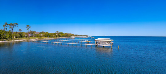 Panoramic landscape of the scenic bay with piers over vibrant blue water