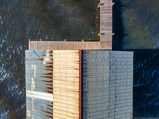 Aerial view of gabled roof and pier against saltwater bay in Navarre Florida