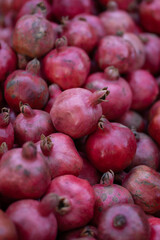 Pile of ripe pomegranates fruits closeup at the farmers market in Tbilisi Georgia. 