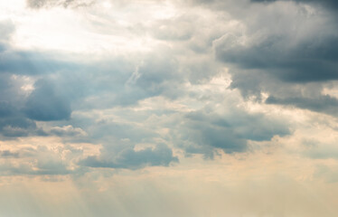 Dramatic Sky Background with sunny beams. Panoramic view of Stormy Clouds in Dark sky