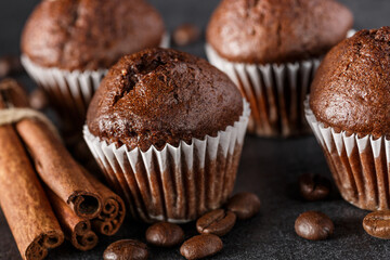 Chocolate cupcake with icing and chocolate bar in Dark lighting,Homemade delicious chocolate muffin on wooden background close-up