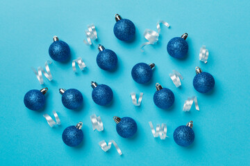 Christmas balls on color background, top view