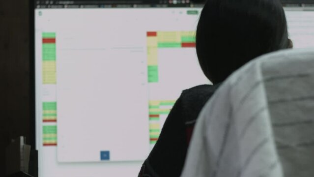 Young Female Office Employee Performs Tasks at Her Desk 4K