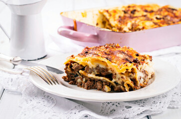 Traditional Italian lasagne baked with pasta sheets and mincemeat and served as close-up on classic design plate