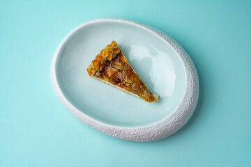 cheesecake with figs on a plate on a colored background