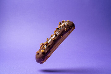 eclair with chocolate on a colored background