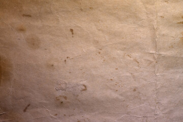A photograph of an old yellowed blank sheet of paper.Clean vintage blank crumpled sheet of paper with stains.