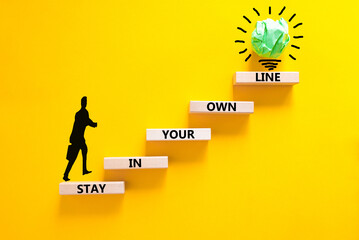 Stay in your own line symbol. Concept words Stay in your own line on wooden blocks. Businessman icon. Beautiful yellow table yellow background. Business and stay in your own line concept. Copy space.