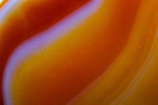 Abstract macro picture of an orange carnelian agate chalcedony tumbled crystal. Banded agate wallpaper interesting lines
Orange natural wallpaper abstract lines