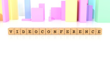 Letters VIDEOCONFERENCE carved on wooden blocks reflected on the beautiful table. Business concept. In the back are colorful cuboids in different shapes. (3D rendering)