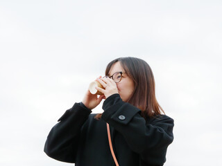 Beautiful Japanese woman drinking a hot coffee outside - 540135053