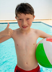 Portrait of a little boy in swimming shorts.