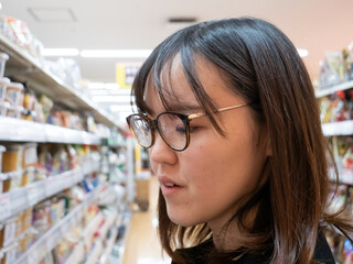 A young Japanese woman grocery shopping - 540137604