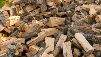 A big mountain of chopped wood for the stove. A big pile of firewood for ignition. Harvesting wood for heating for the winter in the village
