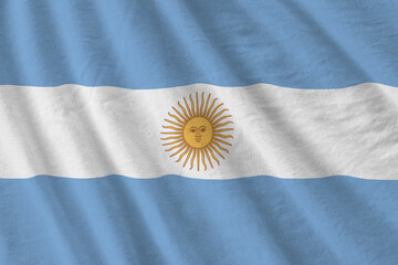 Argentina flag with big folds waving close up under the studio light indoors. The official symbols...