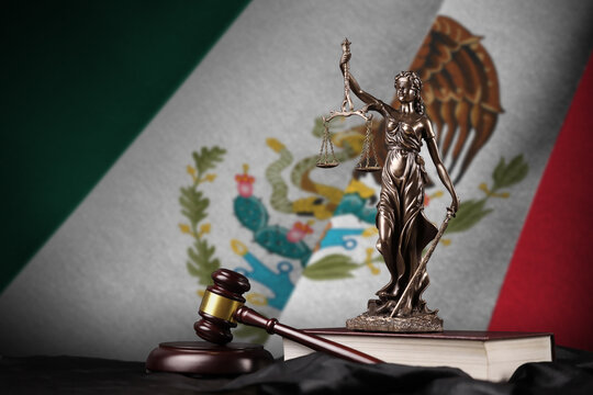 Mexico flag with statue of lady justice, constitution and judge hammer on black drapery. Concept of judgement and guilt