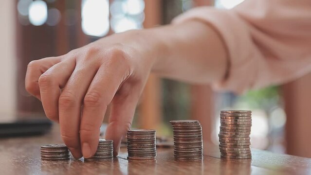 businessman holding coins putting in glass with using calculator to calculate concept saving money for finance accounting, Business, finance, investment, Financial planning.
