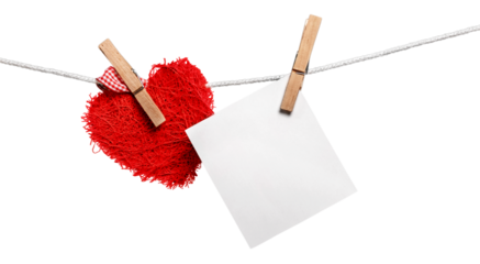 Red decorative heart and white card on rope on  white background