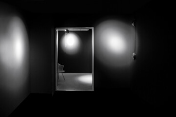 Mysterious abstract image of two dark black empty rooms , spotlight illumination, doorway, nobody