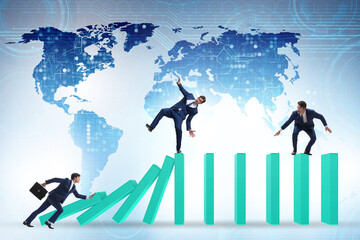 Businessman in domino effect concept