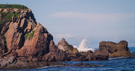 Fototapeta na wymiar waves splashing between rocks