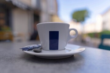 Cup of coffee on a table outside a cafe